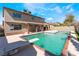 Backyard pool and spa with diving board, brick border, and covered patio against a two-story home at 1009 N Tenaya Way, Las Vegas, NV 89128