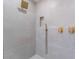 Modern shower featuring neutral tile, gold hardware, handheld sprayer and tiled shower niche at 1009 N Tenaya Way, Las Vegas, NV 89128