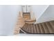 Staircase featuring carpeted steps, wood floors, and a metal railing at 1009 N Tenaya Way, Las Vegas, NV 89128