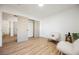 Bright bedroom with wood-look floors, a closet, and neutral decor, creating a serene space at 10229 Birch Bluff Ln, Las Vegas, NV 89145