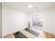 Bright room featuring wood floors, a sliding glass door, and minimal decor for a tranquil space at 10229 Birch Bluff Ln, Las Vegas, NV 89145