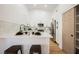 Bright kitchen featuring white cabinets, stainless steel appliances, and a convenient breakfast bar area at 10229 Birch Bluff Ln, Las Vegas, NV 89145