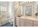 Floral bathroom with a marble vanity, bathtub, and vibrant wallpaper at 10548 Findlay Ave, Las Vegas, NV 89134
