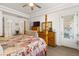 Bright bedroom featuring a four-poster bed, wooden dresser, and ample natural light at 10548 Findlay Ave, Las Vegas, NV 89134