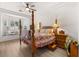 Spacious bedroom with a four-poster bed, bay windows with seats, and stylish decor at 10548 Findlay Ave, Las Vegas, NV 89134