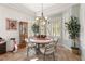Charming dining room featuring decorative wallpaper, a round table, and a beautiful chandelier at 10548 Findlay Ave, Las Vegas, NV 89134