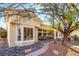 Back of house with outdoor seating area, desert landscaping, and a stone walkway at 10548 Findlay Ave, Las Vegas, NV 89134