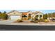 Beautiful single-story home with a desert landscape, attached garage, arched entryway and tile roof at 10548 Findlay Ave, Las Vegas, NV 89134