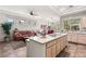 Open kitchen with an island cooktop and adjacent living area at 10548 Findlay Ave, Las Vegas, NV 89134