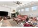 Comfortable living room featuring a fireplace, television, and lots of natural light at 10548 Findlay Ave, Las Vegas, NV 89134