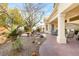 Covered back patio offering serene views of desert landscaping and mature trees at 10548 Findlay Ave, Las Vegas, NV 89134