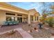 Back of house with outdoor seating area, desert landscaping, and a stone walkway at 10548 Findlay Ave, Las Vegas, NV 89134