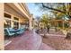 Back patio with a covered seating area, landscaping, and access to the backyard at 10548 Findlay Ave, Las Vegas, NV 89134