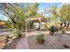 Beautiful outdoor pergola with seating and desert landscaping create a tranquil backyard retreat at 10548 Findlay Ave, Las Vegas, NV 89134