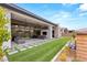 Outdoor living space featuring a covered patio with furniture, artificial turf and a rock water feature at 10794 White Clay Dr, Las Vegas, NV 89135