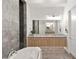 Modern bathroom featuring a free-standing tub, and a dual sink vanity with granite counters at 10794 White Clay Dr, Las Vegas, NV 89135