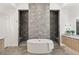 Contemporary bathroom featuring a free-standing tub, dual shower stalls, and modern fixtures at 10794 White Clay Dr, Las Vegas, NV 89135