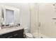 Modern bathroom featuring a glass enclosed shower, a dark vanity with light countertop, and sleek fixtures at 10794 White Clay Dr, Las Vegas, NV 89135