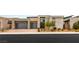 Contemporary home boasts a two-car garage, neutral color scheme, and professionally landscaped front yard at 10794 White Clay Dr, Las Vegas, NV 89135