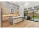 Modern kitchen featuring a central island, stainless steel appliances, and seamless access to the outdoor area at 10794 White Clay Dr, Las Vegas, NV 89135