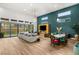 Spacious living room with modern décor, dining area, and sliding glass doors leading to backyard at 10794 White Clay Dr, Las Vegas, NV 89135