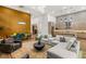 Open-concept living room featuring a modern kitchen, dining area, and comfortable seating arrangement at 10794 White Clay Dr, Las Vegas, NV 89135