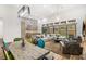 Spacious living area with dining table, modern design elements, and outdoor views at 10794 White Clay Dr, Las Vegas, NV 89135