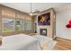 Bright and airy main bedroom featuring an electric fireplace and a door to the yard at 10794 White Clay Dr, Las Vegas, NV 89135