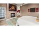 Relaxing main bedroom featuring an electric fireplace, ceiling fan, and a door to the yard at 10794 White Clay Dr, Las Vegas, NV 89135