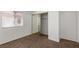 Open sliding mirrored closet in bedroom with carpet and window at 1333 Pinto Rock Ln # 202, Las Vegas, NV 89128