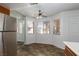 Bright breakfast nook with three windows, ceiling fan, and stainless steel refrigerator at 1333 Pinto Rock Ln # 202, Las Vegas, NV 89128