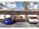 Assigned carport parking area with covered spots, building numbers, and landscaping at 1333 Pinto Rock Ln # 202, Las Vegas, NV 89128