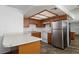 Kitchen with wood cabinets, laminate countertops, and modern appliances at 1333 Pinto Rock Ln # 202, Las Vegas, NV 89128