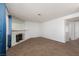 Cozy living room featuring neutral carpet, a white fireplace, and a window at 1333 Pinto Rock Ln # 202, Las Vegas, NV 89128