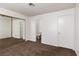 Carpeted main bedroom with mirrored closet, bathroom entrance, and white door at 1333 Pinto Rock Ln # 202, Las Vegas, NV 89128