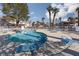 Community pool with lounge chairs, landscaping, and nearby buildings at 1333 Pinto Rock Ln # 202, Las Vegas, NV 89128
