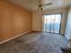 Bedroom featuring a sliding glass door, carpet flooring, and ceiling fan at 1904 Las Palmas Ln # 101, Laughlin, NV 89029