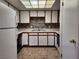 Well-lit kitchen featuring white cabinets, a patterned backsplash, and essential appliances for cooking at 1904 Las Palmas Ln # 101, Laughlin, NV 89029