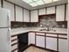 Functional kitchen with white cabinets, stylish backsplash, and standard appliances for everyday cooking at 1904 Las Palmas Ln # 101, Laughlin, NV 89029