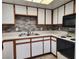 Practical kitchen showcasing white cabinets, neutral backsplash, and appliances for a cozy cooking space at 1904 Las Palmas Ln # 101, Laughlin, NV 89029