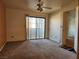 Neutral living room with sliding glass door and ceiling fan for a bright and airy feel at 1904 Las Palmas Ln # 101, Laughlin, NV 89029