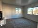 Inviting living room with neutral carpet, bright windows, and a cozy fireplace on a sunny day at 1904 Las Palmas Ln # 101, Laughlin, NV 89029