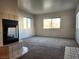 Bright living room featuring neutral walls, carpet, and view of the exterior through large windows at 1904 Las Palmas Ln # 101, Laughlin, NV 89029