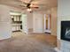 Open-concept living room featuring a fireplace, ceiling fan, and a view into the adjoining kitchen at 1904 Las Palmas Ln # 101, Laughlin, NV 89029
