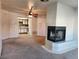 Spacious living room showcasing a fireplace, ceiling fan, and an open view to the kitchen area at 1904 Las Palmas Ln # 101, Laughlin, NV 89029
