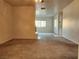 Wide-angle view of a living room with access to other rooms, featuring carpeted flooring and neutral walls at 1904 Las Palmas Ln # 101, Laughlin, NV 89029