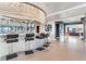 Chic bar area with a modern chandelier, seating, and views into the living room at 200 W Sahara Ave # 4101, Las Vegas, NV 89102