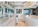 Modern condo bar boasts marble countertop, mirrored backsplash, and unique hanging chandelier lights at 200 W Sahara Ave # 4101, Las Vegas, NV 89102