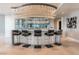 Modern bar area with seating, mirrored backdrop, and elegant chandelier lighting at 200 W Sahara Ave # 4101, Las Vegas, NV 89102