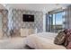 Bright modern bedroom with designer wallpaper, dresser, and access to the terrace at 200 W Sahara Ave # 4101, Las Vegas, NV 89102